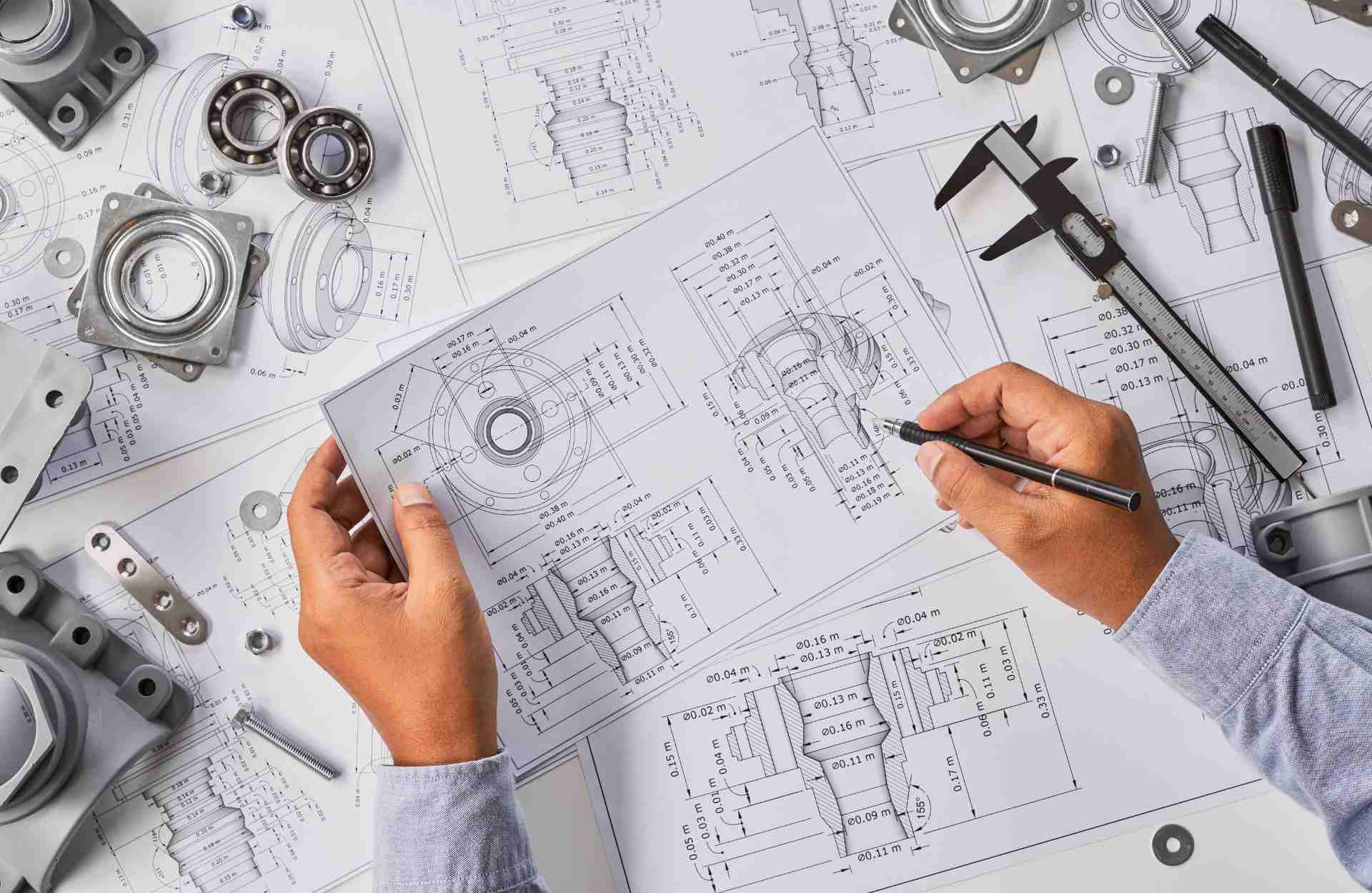 Engineer technician designing drawings mechanicalÂ parts engineering Engine